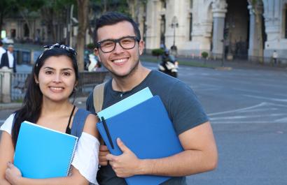 two students with notebooks in their hands